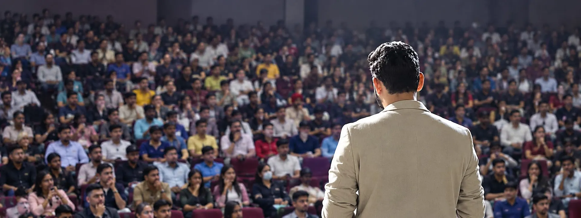 Chandan Sanwal on stage in front of a full auditorium
